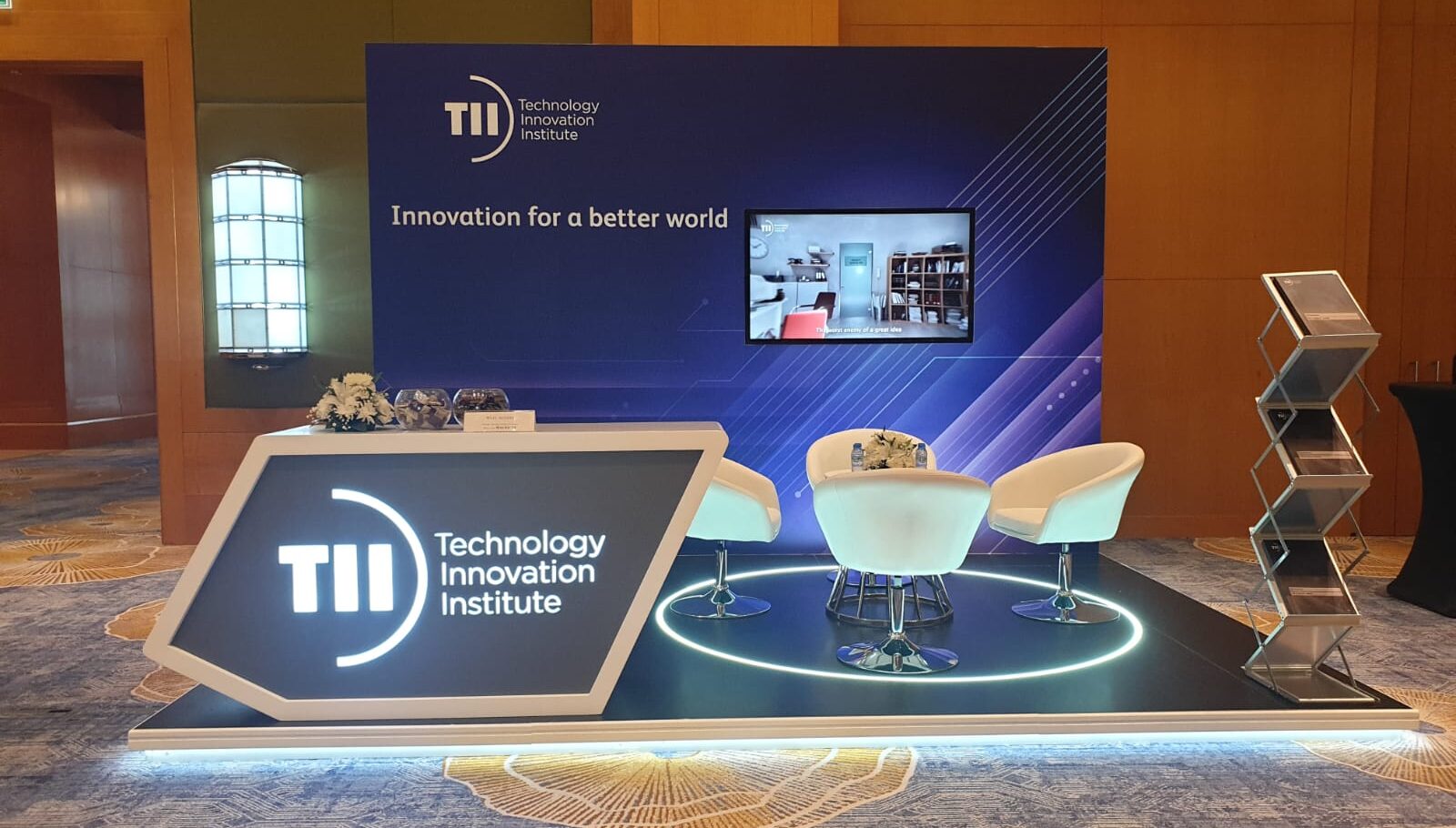 Modern exhibition booth setup with vibrant displays and branding at a trade show event, showcasing Sonic Media Pro's professional design and setup services in the UAE